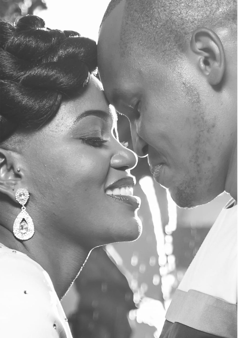 Black and white close-up of bride and groom foreheads touching